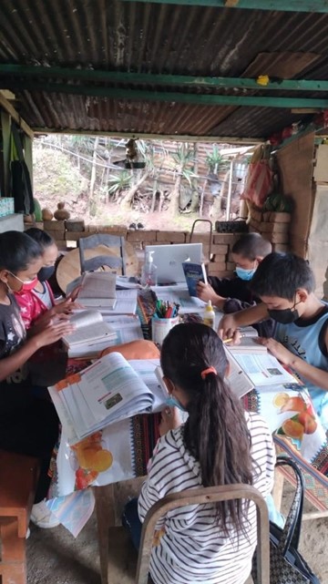 A group of children sitting at a table doing school work