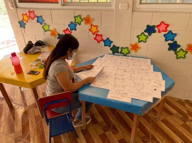 Woman at a table with papers